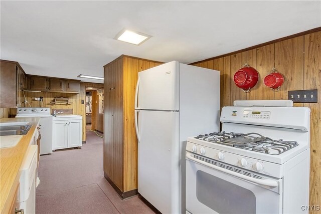 329 Hazelhurst Ave, Syracuse, NY 13206 - kitchen featuring white appliances, washer / dryer, wooden walls, light countertops, and a sink