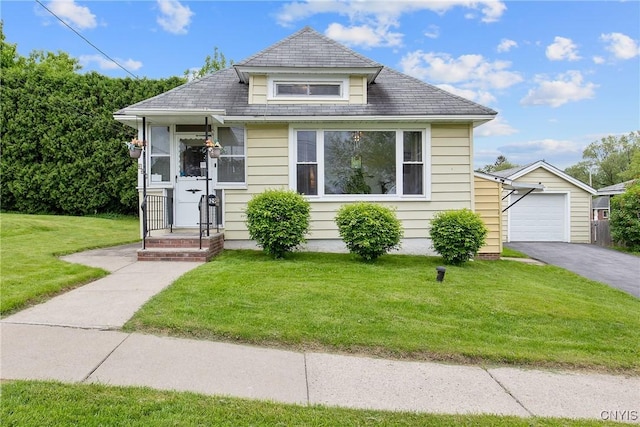 329 Hazelhurst Ave, Syracuse, NY 13206 - bungalow-style home with an outbuilding, a front yard, asphalt driveway, and a detached garage