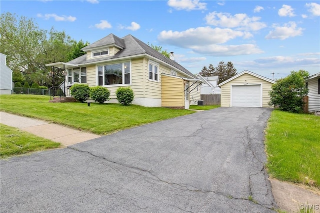 329 Hazelhurst Ave, Syracuse, NY 13206 - view of front facade with a detached garage, an outdoor structure, asphalt driveway, and central air condition unit