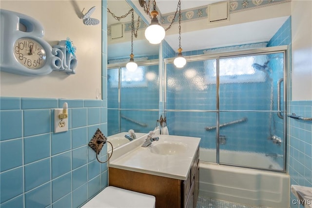 329 Hazelhurst Ave, Syracuse, NY 13206 - full bathroom featuring tile walls, vanity, and combined bath / shower with glass door