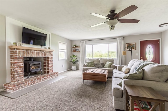 2935 Main St, York, NY 14533 - carpeted living area featuring a wood stove, ceiling fan, and baseboards