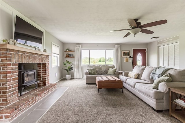 2935 Main St, York, NY 14533 - living room with a wood stove, a ceiling fan, carpet, and baseboards