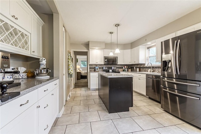 2935 Main St, York, NY 14533 - kitchen featuring stainless steel appliances, backsplash, a center island, white cabinets, and light tile patterned floors