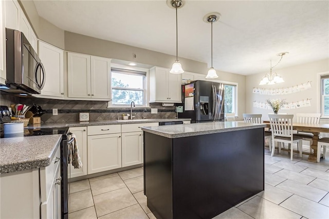 2935 Main St, York, NY 14533 - kitchen with appliances with stainless steel finishes, a sink, decorative backsplash, and healthy amount of natural light