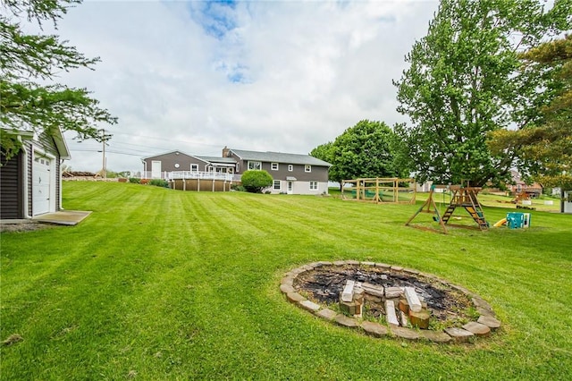 2935 Main St, York, NY 14533 - view of grassy yard with a playground and an outdoor fire pit