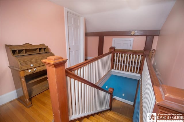 10280 Christy Rd, Sheridan, NY 14063 - staircase featuring wood finished floors, lofted ceiling, and baseboards