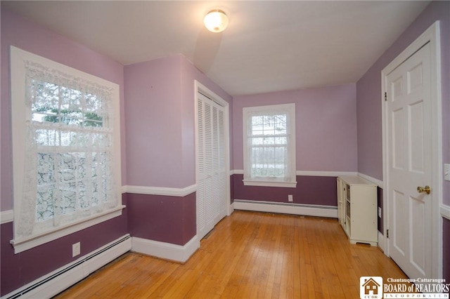 10280 Christy Rd, Sheridan, NY 14063 - unfurnished bedroom with baseboard heating, light wood finished floors, a closet, and baseboards