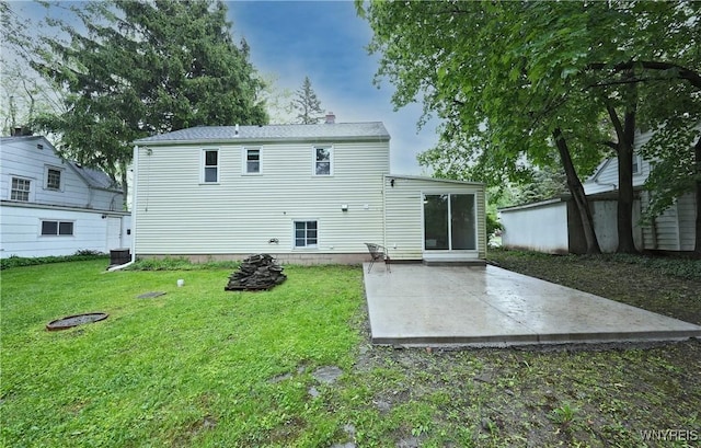 4334 Connection Dr, Clarence, NY 14221 - back of property featuring a patio area, a lawn, central air condition unit, and a chimney