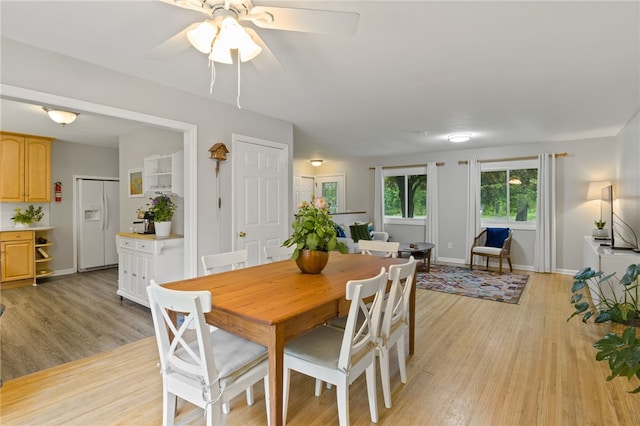 482 Marsh Rd, Pittsford, NY 14534 - dining room with light wood-style flooring, a ceiling fan, and baseboards
