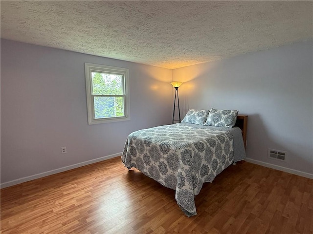 300 Amy Ln, Clarkson, NY 14420 - bedroom with a textured ceiling, wood finished floors, and baseboards