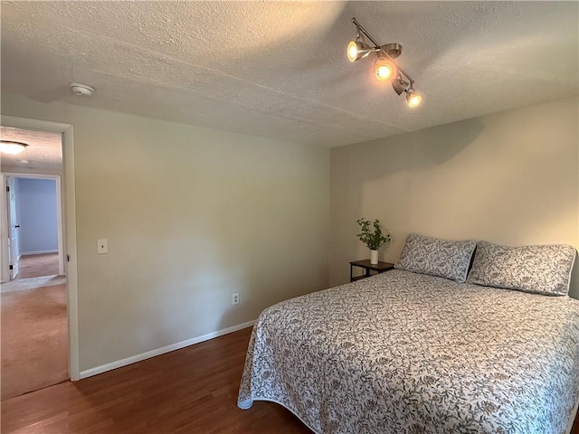 300 Amy Ln, Clarkson, NY 14420 - bedroom with a textured ceiling, wood finished floors, and baseboards