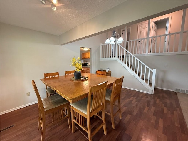 300 Amy Ln, Clarkson, NY 14420 - dining space featuring wood finished floors, baseboards, stairway, a chandelier, and a textured ceiling