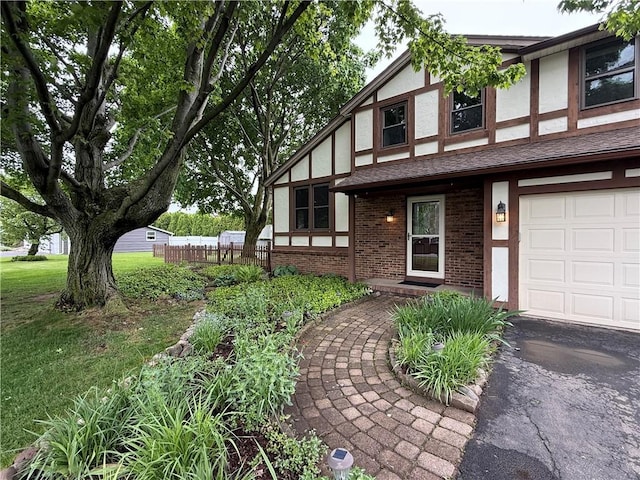 300 Amy Ln, Clarkson, NY 14420 - tudor-style house with stucco siding, brick siding, and asphalt driveway