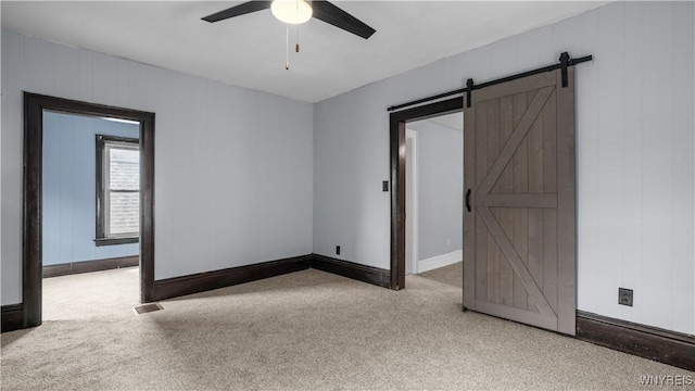 35 Duerstein St, Buffalo, NY 14210 - carpeted spare room featuring ceiling fan, a barn door, and baseboards
