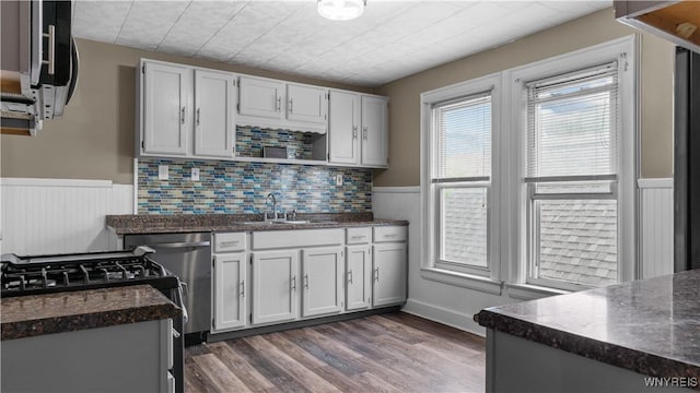 35 Duerstein St, Buffalo, NY 14210 - kitchen featuring wainscoting, dishwashing machine, a sink, stainless steel microwave, and dark wood-style flooring