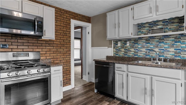 35 Duerstein St, Buffalo, NY 14210 - kitchen with stainless steel appliances, a sink, white cabinetry, and wainscoting