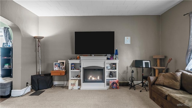 35 Duerstein St, Buffalo, NY 14210 - carpeted living room featuring a glass covered fireplace, baseboards, and arched walkways