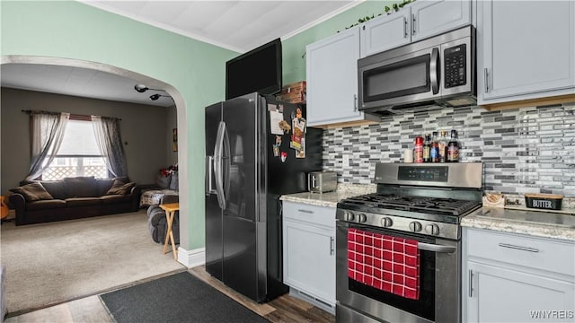 35 Duerstein St, Buffalo, NY 14210 - kitchen featuring appliances with stainless steel finishes, arched walkways, open floor plan, tasteful backsplash, and ornamental molding
