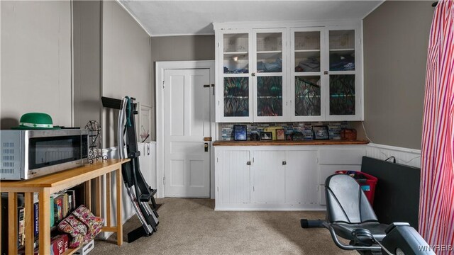 35 Duerstein St, Buffalo, NY 14210 - kitchen with stainless steel microwave, light colored carpet, glass insert cabinets, white cabinets, and tasteful backsplash
