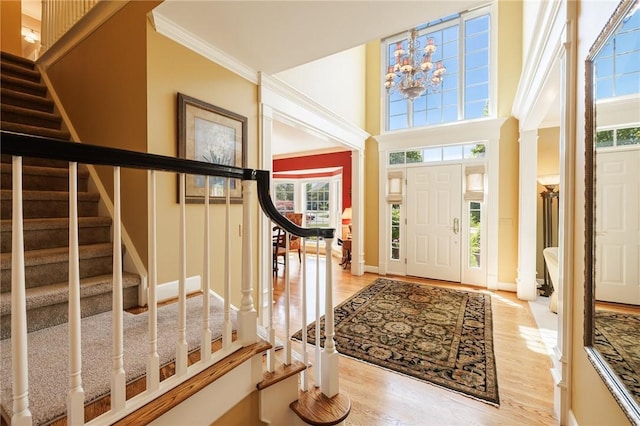 72 Meadow Cove Rd, Pittsford, NY 14534 - foyer with stairway, healthy amount of natural light, light wood-style flooring, ornamental molding, and a chandelier
