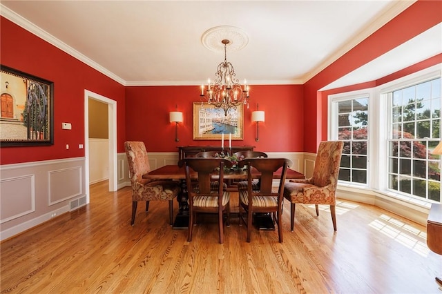 72 Meadow Cove Rd, Pittsford, NY 14534 - dining space featuring a chandelier, light wood finished floors, ornamental molding, and a wainscoted wall