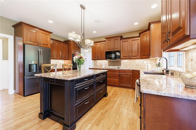 72 Meadow Cove Rd, Pittsford, NY 14534 - kitchen featuring black appliances, a sink, light wood finished floors, a center island, and recessed lighting