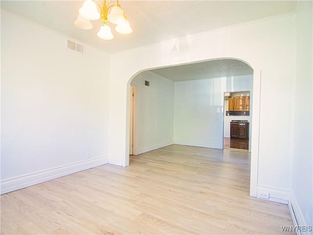40 Federal Ave, Buffalo, NY 14215 - unfurnished room with arched walkways, a chandelier, light wood finished floors, crown molding, and baseboards