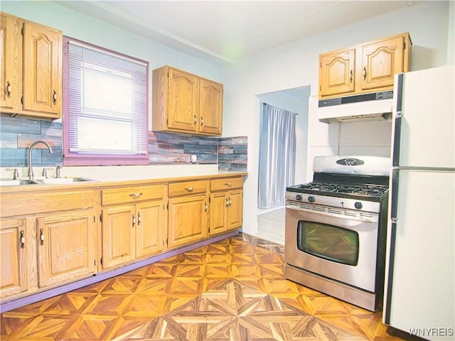 40 Federal Ave, Buffalo, NY 14215 - kitchen featuring freestanding refrigerator, under cabinet range hood, stainless steel gas range oven, a sink, and light countertops