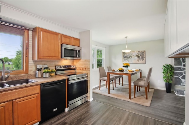 1099 N Greece Rd, Greece, NY 14626 - kitchen with appliances with stainless steel finishes, a sink, decorative backsplash, dark wood-style flooring, and baseboards