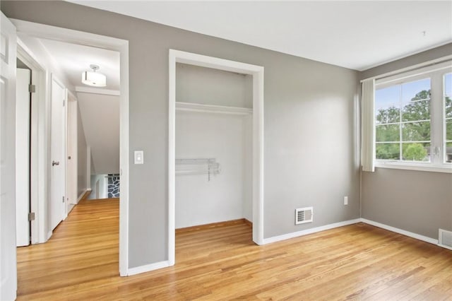 1099 N Greece Rd, Greece, NY 14626 - unfurnished bedroom with light wood-type flooring, a closet, and baseboards