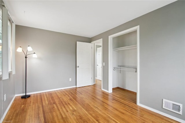 1099 N Greece Rd, Greece, NY 14626 - unfurnished bedroom with light wood-style floors, a closet, and baseboards