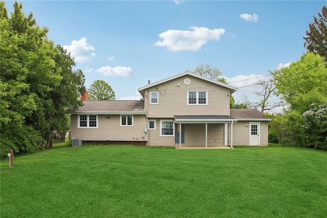1099 N Greece Rd, Greece, NY 14626 - back of property with a yard, central AC unit, a chimney, and a patio