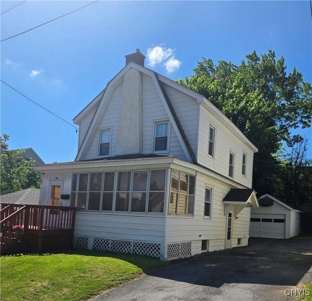 116 Mariposa St, Syracuse, NY 13206 - view of property exterior featuring an outbuilding, a chimney, a wooden deck, a detached garage, and a lawn