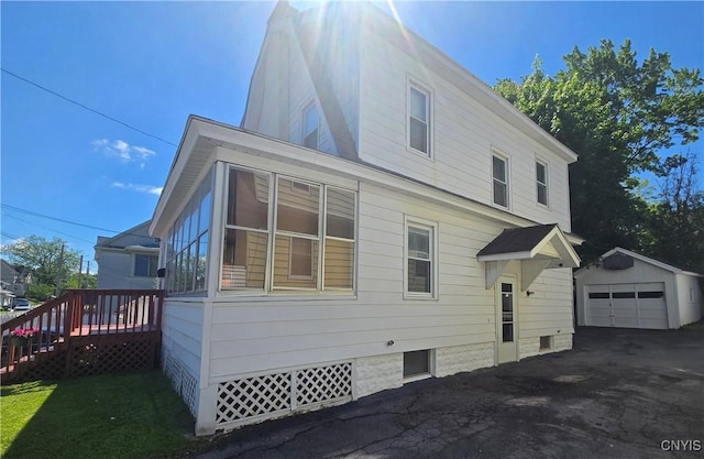 116 Mariposa St, Syracuse, NY 13206 - view of side of property featuring an outbuilding, a garage, and asphalt driveway