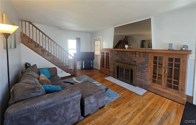 116 Mariposa St, Syracuse, NY 13206 - living area with wood-type flooring, stairway, a brick fireplace, and crown molding