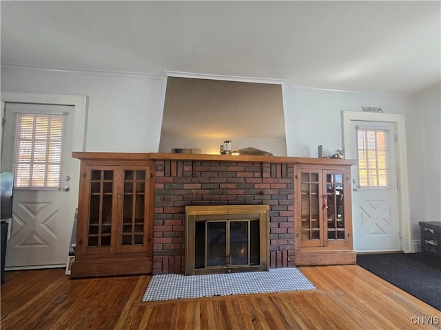 116 Mariposa St, Syracuse, NY 13206 - unfurnished living room featuring a fireplace, wood finished floors, and crown molding