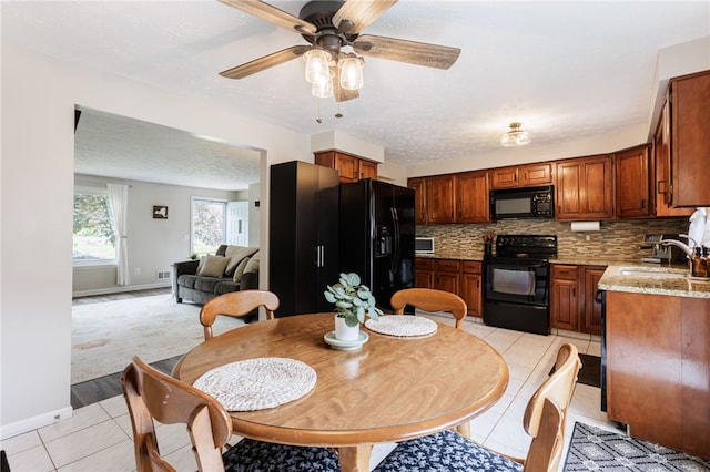 25 Selkirk Dr, Greece, NY 14626 - dining space featuring light tile patterned floors, a ceiling fan, and baseboards