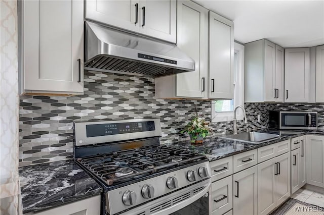 1597 Kensington Ave, Cheektowaga, NY 14215 - kitchen featuring stainless steel appliances, under cabinet range hood, a sink, decorative backsplash, and dark stone countertops