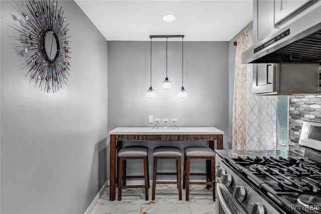 1597 Kensington Ave, Cheektowaga, NY 14215 - kitchen with range hood, stainless steel range with gas stovetop, light marble finish floors, backsplash, and baseboards