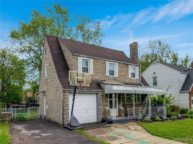 1597 Kensington Ave, Cheektowaga, NY 14215 - view of front of house with stone siding, a porch, a chimney, and an attached garage