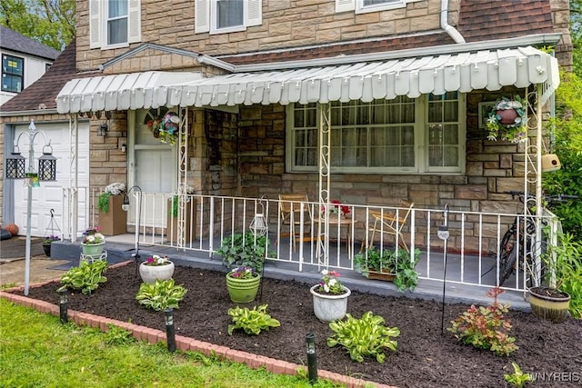 1597 Kensington Ave, Cheektowaga, NY 14215 - view of exterior entry featuring stone siding and a shingled roof