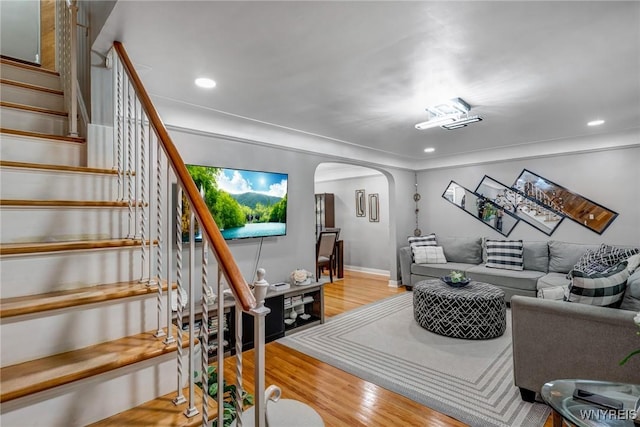 1597 Kensington Ave, Cheektowaga, NY 14215 - living room with arched walkways, light wood-style flooring, stairway, recessed lighting, and baseboards