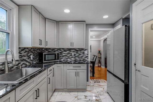 1597 Kensington Ave, Cheektowaga, NY 14215 - kitchen with stainless steel appliances, a sink, light marble finish flooring, backsplash, and recessed lighting