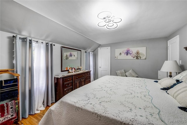 1597 Kensington Ave, Cheektowaga, NY 14215 - bedroom with light wood finished floors and vaulted ceiling