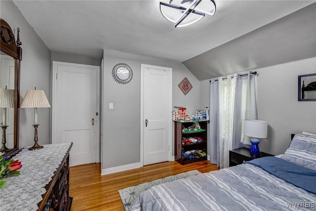 1597 Kensington Ave, Cheektowaga, NY 14215 - bedroom featuring light wood-style floors, lofted ceiling, and baseboards