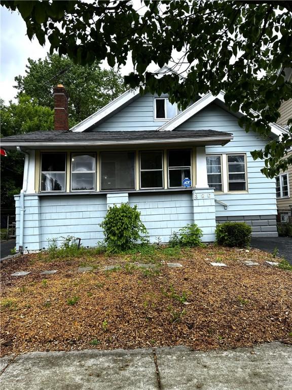 386 Westfield St, Rochester, NY 14619 - bungalow-style house with a shingled roof and a chimney