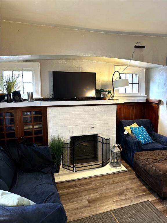 386 Westfield St, Rochester, NY 14619 - living area featuring wood finished floors, a fireplace, and plenty of natural light