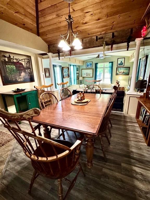 450 Stover Rd, Tyrone, NY 14815 - dining space with dark wood finished floors, ornate columns, wooden ceiling with exposed beams, and a chandelier