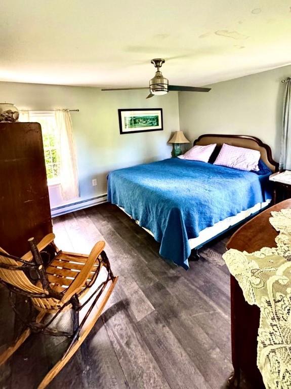 450 Stover Rd, Tyrone, NY 14815 - bedroom featuring baseboard heating, wood finished floors, and ceiling fan