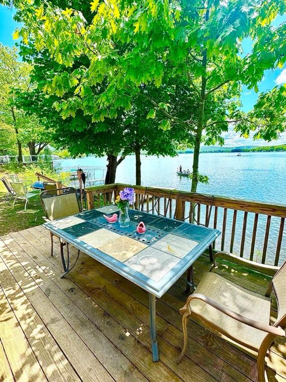 450 Stover Rd, Tyrone, NY 14815 - wooden deck featuring a water view and outdoor dining area